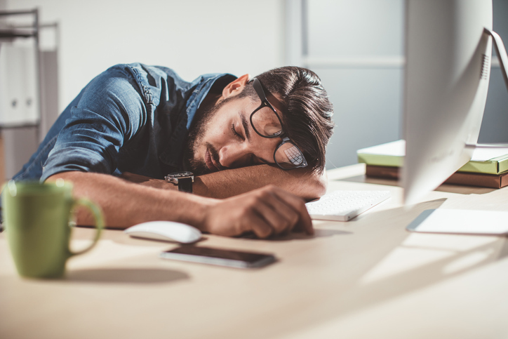 man sleeping on a desk