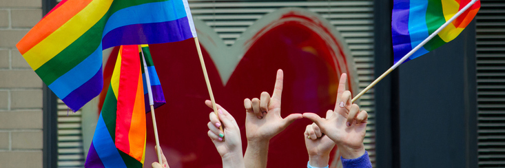 hands with lgbtq flag